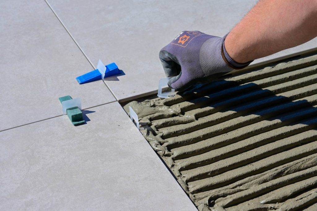 <br>A Close-Up Shot of a Person Putting Tile Levelers